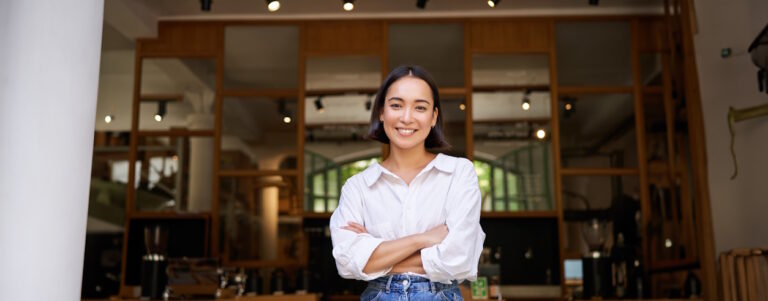 woman smiling in front of business